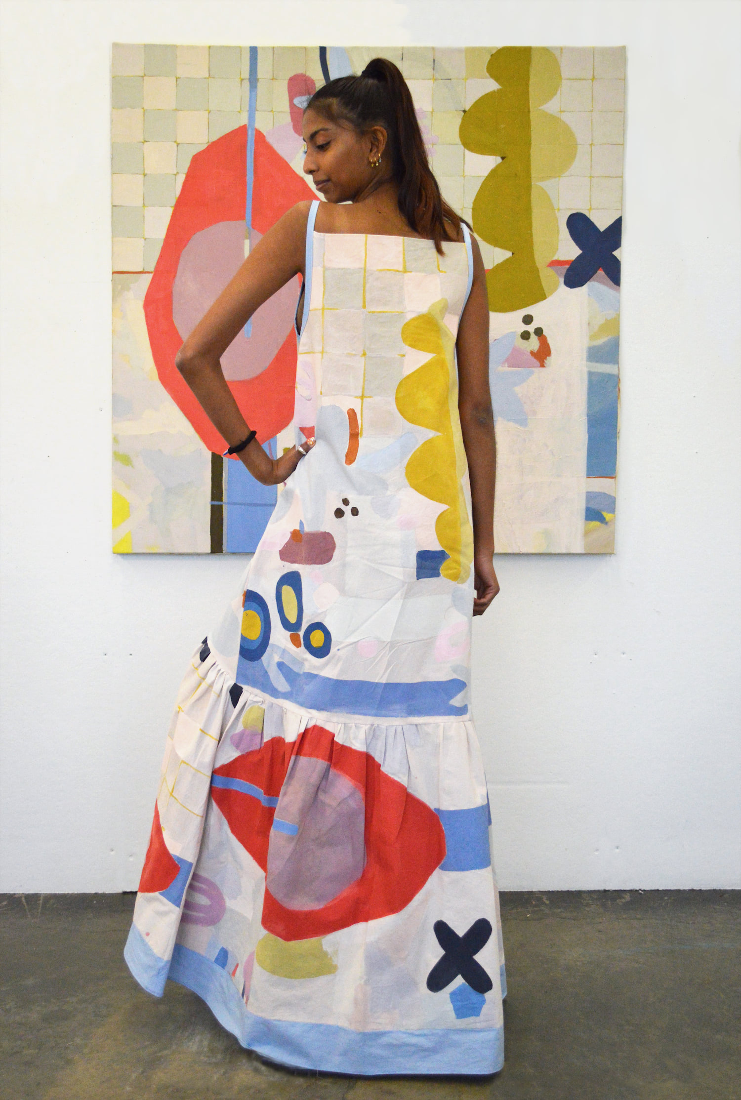 Model standing in front of painting wearing corresponding garment