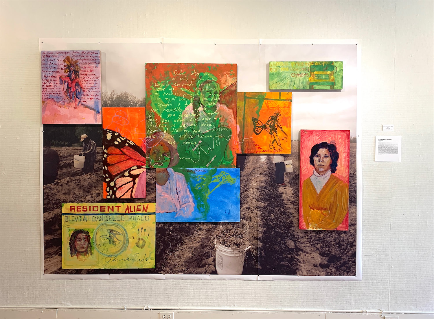 The image contains eight oil painted canvas panels hung over a printed image of field workers. From left to right in the upper row, the first panel contains the figures and story of Popo and Itza, next is a butterfly wing and line drawing of a worker, then a writing in Spanish and two portraits of workers, next a worker and multiple butterflies, finally on the top right in a school bus and quote about education. In the lower row of panels, first is a permanent resident card with a portrait and alternate writing, next is a figure continued from another panel and a figure of a worker, finally there is a portrait of a woman.