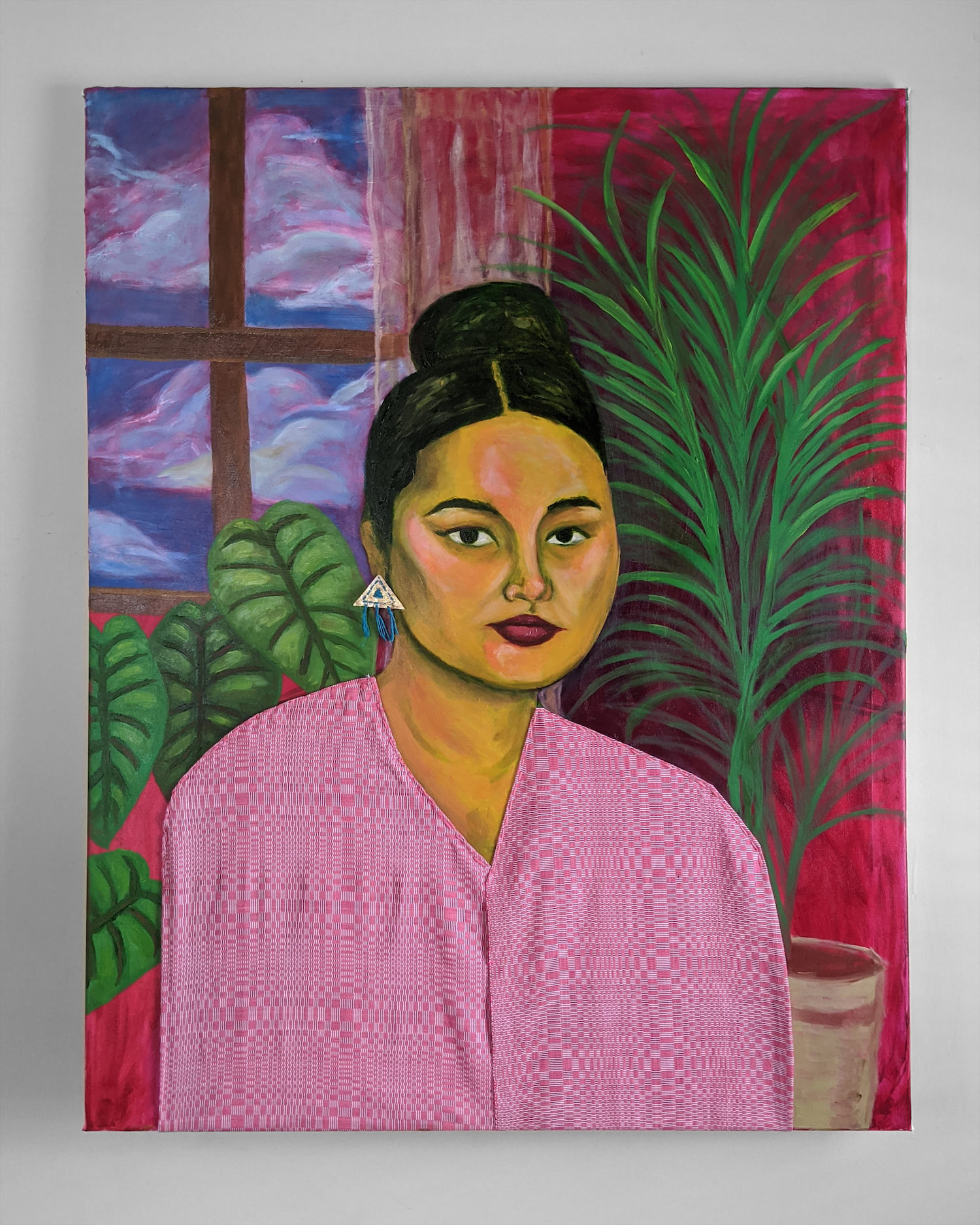 A painting of a woman wearing a pink dress. The dress is cloth attached to the canvas. There is a window behind her and plants in the background. The woman is painted yellow. She is looking directly at the viewer, intensely.