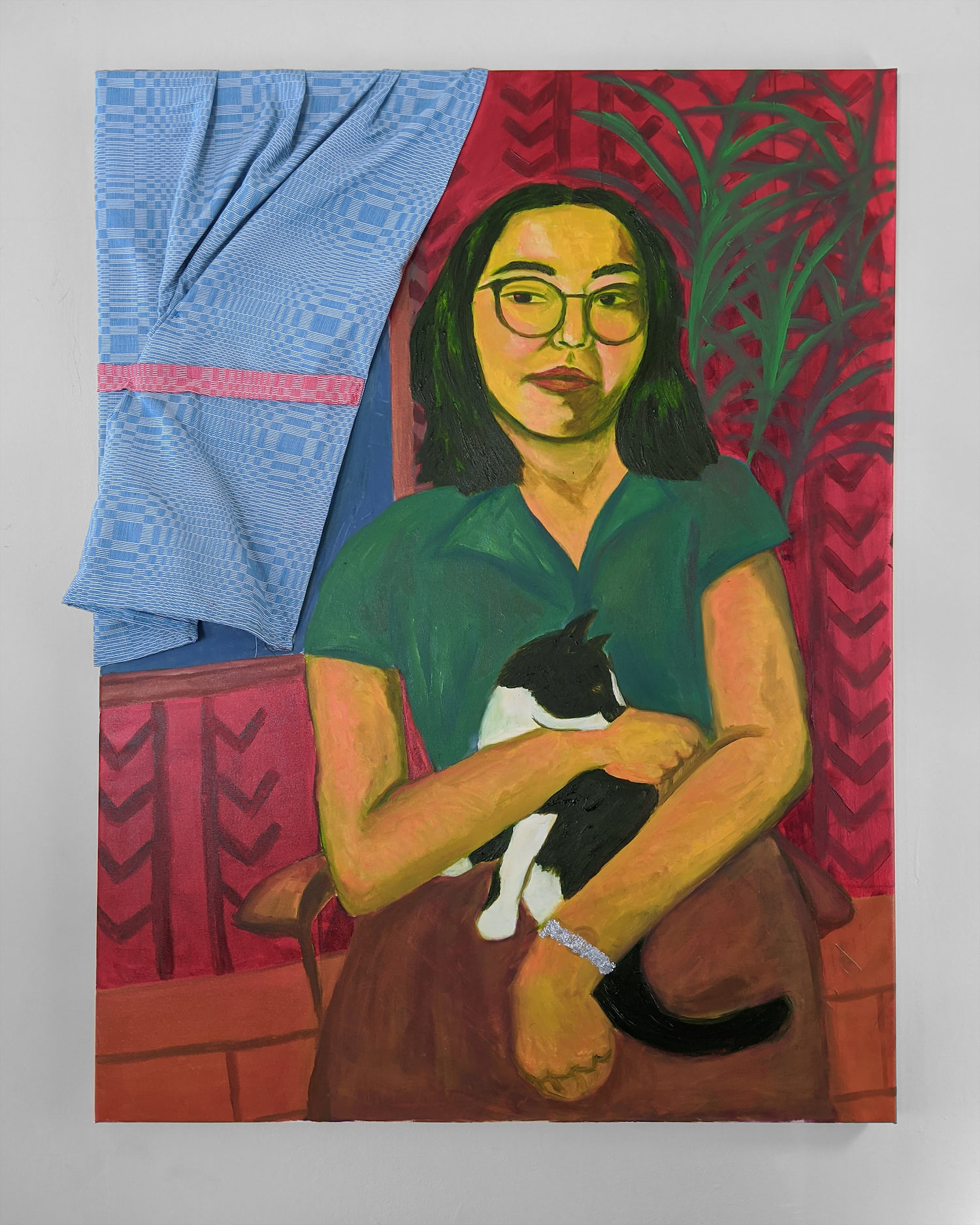 A painting with a woman seated in the center, holding a cat. She is painted yellow. There are plants in the background and fabric attached to canvas to mimic a curtain. The woman is gazing directly at the viewer, looking aloof but strong.