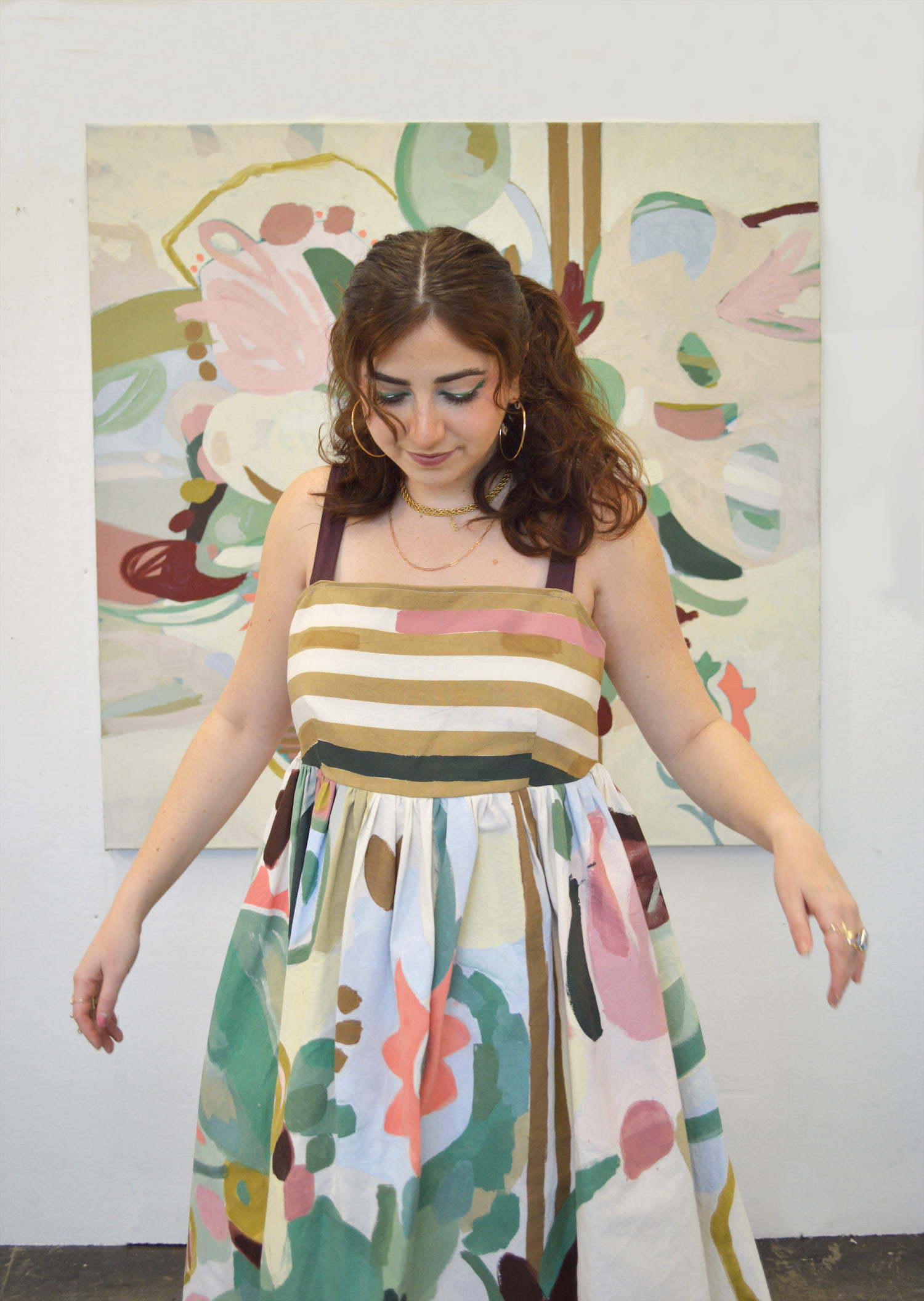 Model standing in front of painting wearing corresponding garment