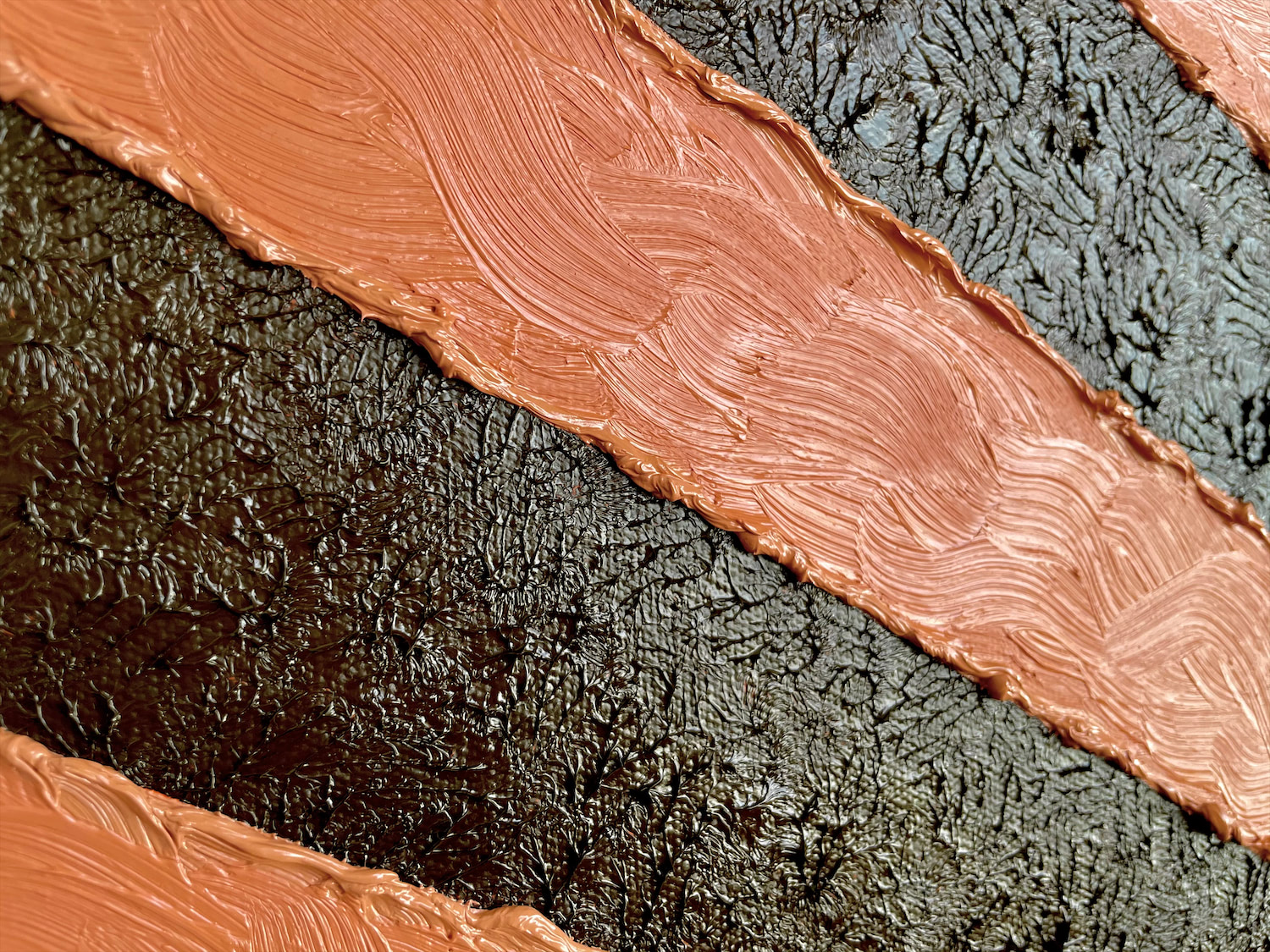 An impasto triptych of a chocolate cake that is installed in the corner