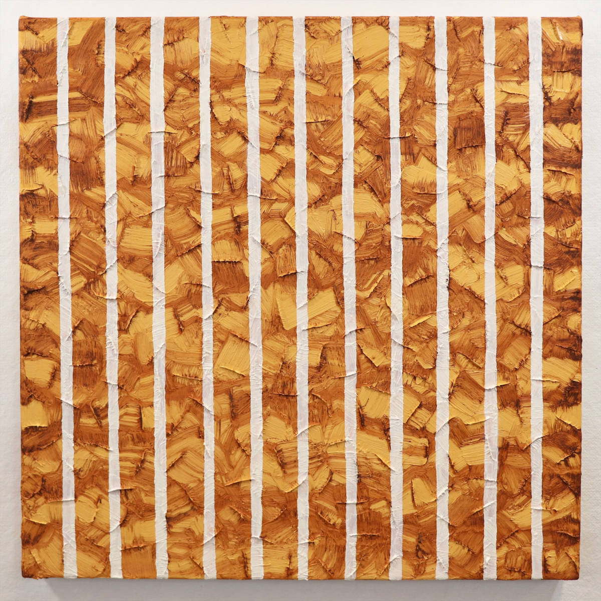 A yellow impasto painting with brown horizontal drips and white vertical stripes