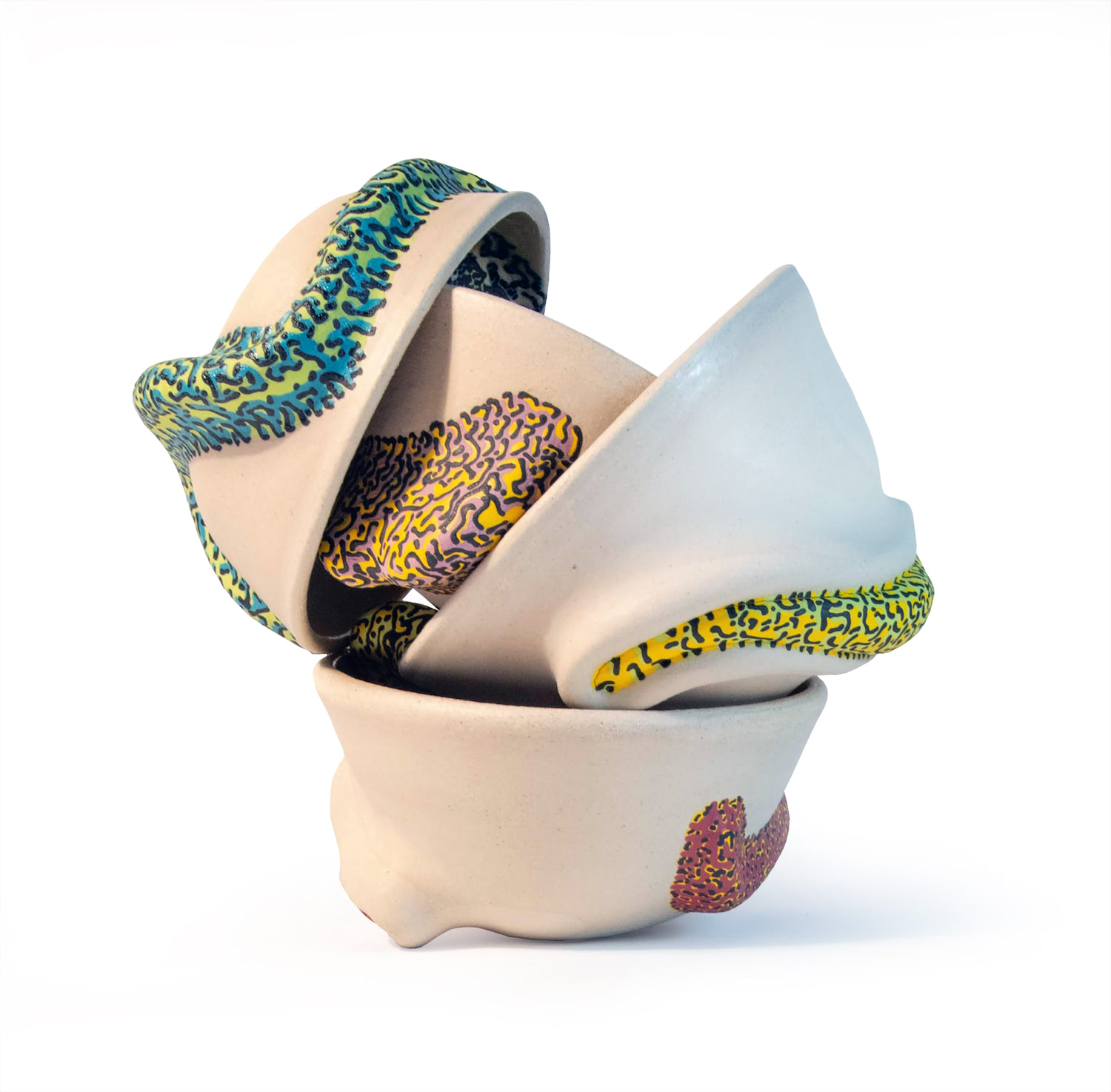 An image of stacked white bowl forms with colorfully patterned sculptural surface additions.