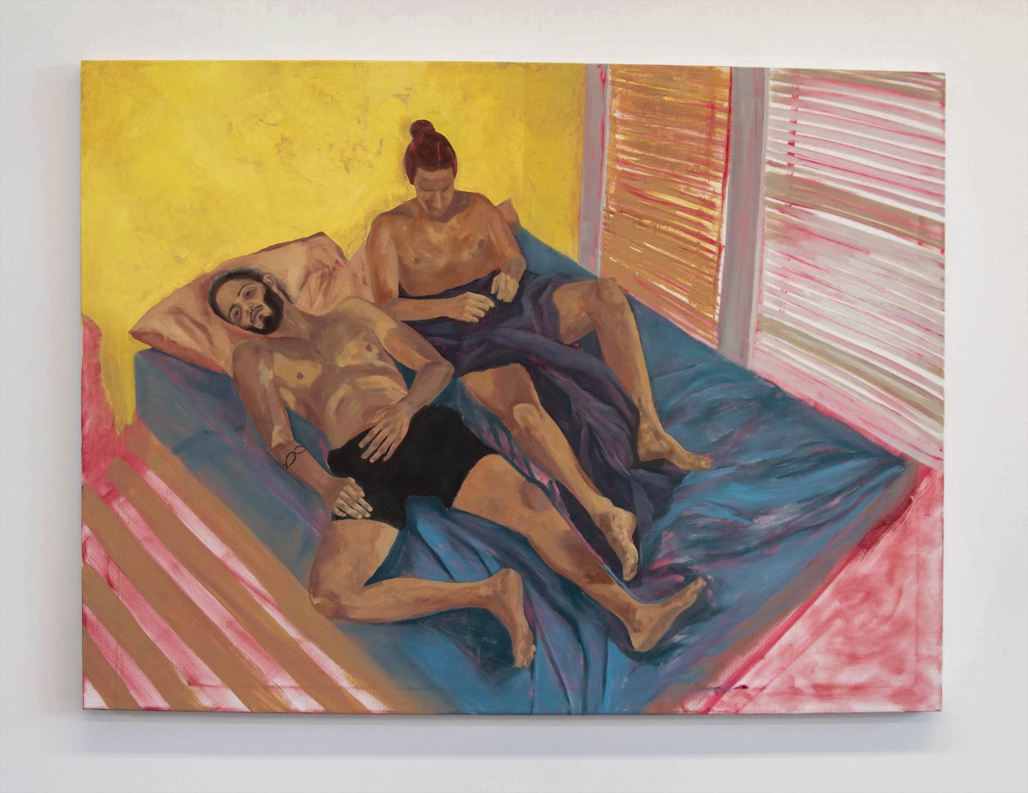 This image shows a horizontal oil painting portraying two men barely touching and laying in bed together, from a high angle. One of the men is making eye contact with the viewer, inviting them into his world of intimacy and vulnerability. Deep reds from the underpainting emanate throughout the painting.