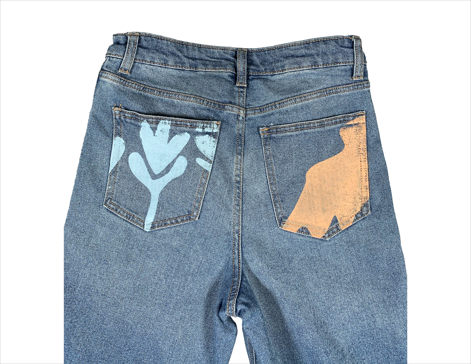 image of back pockets of a pair of jeans. left pocket has a print of a light blue tulip, while right pocket has a print of an orange blob shape.