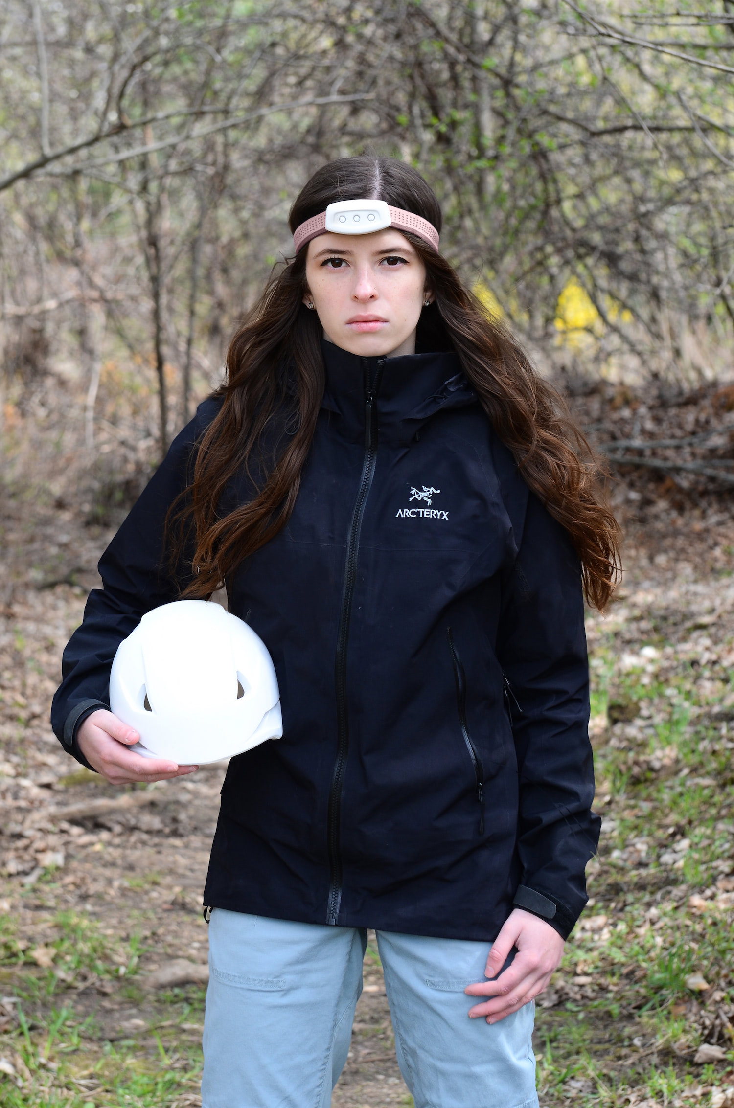 Physical models of the Alpinight helmet and headlamp with a user.