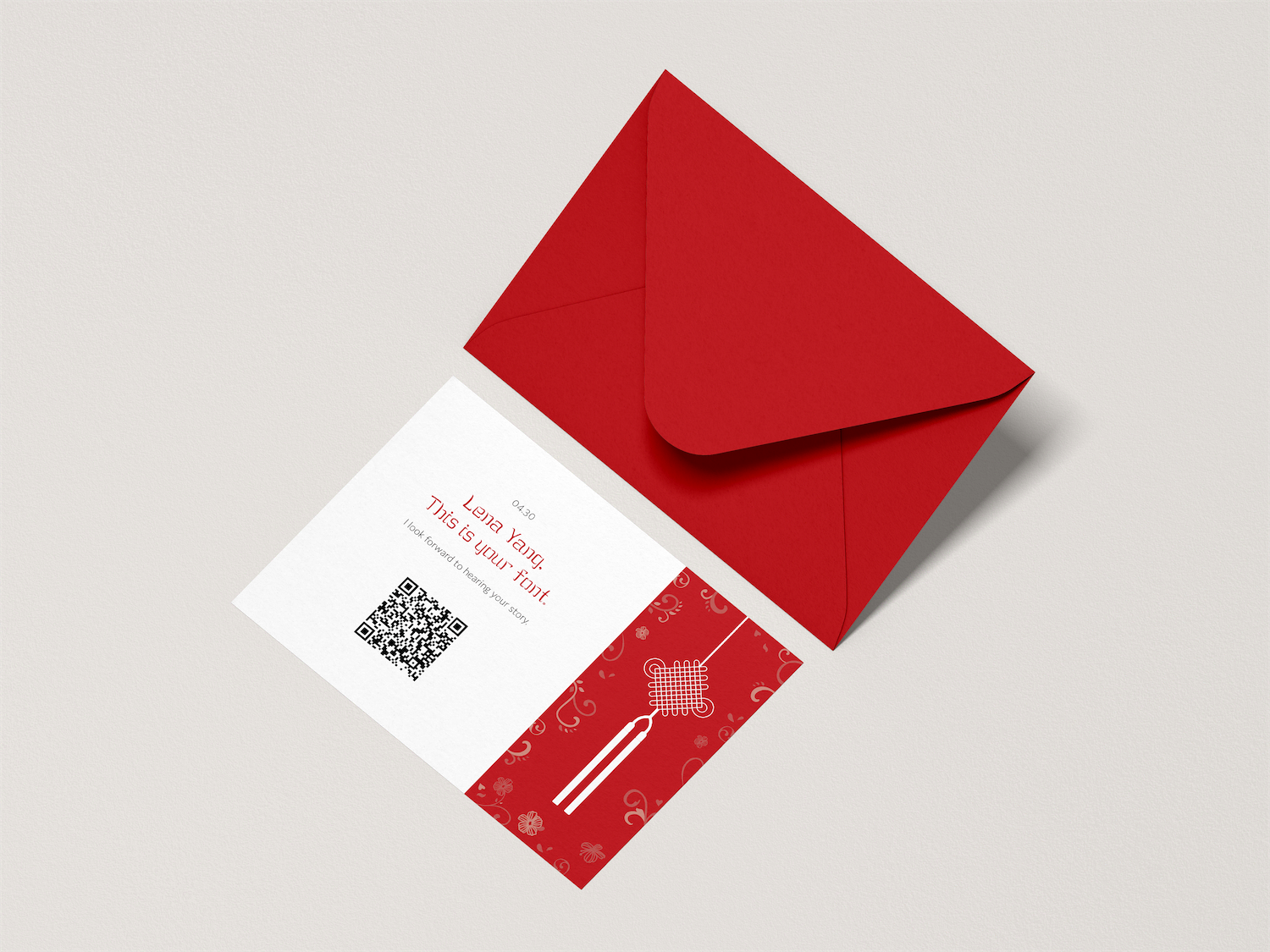 A mockup of the invitation lays next to a deep red envelope.