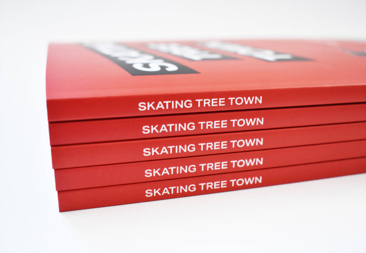 Side view of a stack of five Skating Tree Town books on a white background.