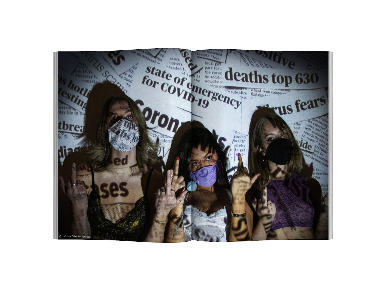 3 Girls wearing face masks and flipping off the camera. There is a projection of famous newspaper headlines over them as they stare into the camera. The model farthest left has short blonde hair with a paler complexion wearing a white polka-dotted face mask and an olive and black lace bralette, the model in the middle is shorter than both the other two and is a tanner skin tone with longer dark brown to black hair and is wearing a purple ruched face mask with a white floral corset top. The model to the farthest right is slightly taller than the girl in the middle and has dark blonde hair and a lighter skin tone and is wearing a black N95 mask with a purple snakeskin mesh shirt.