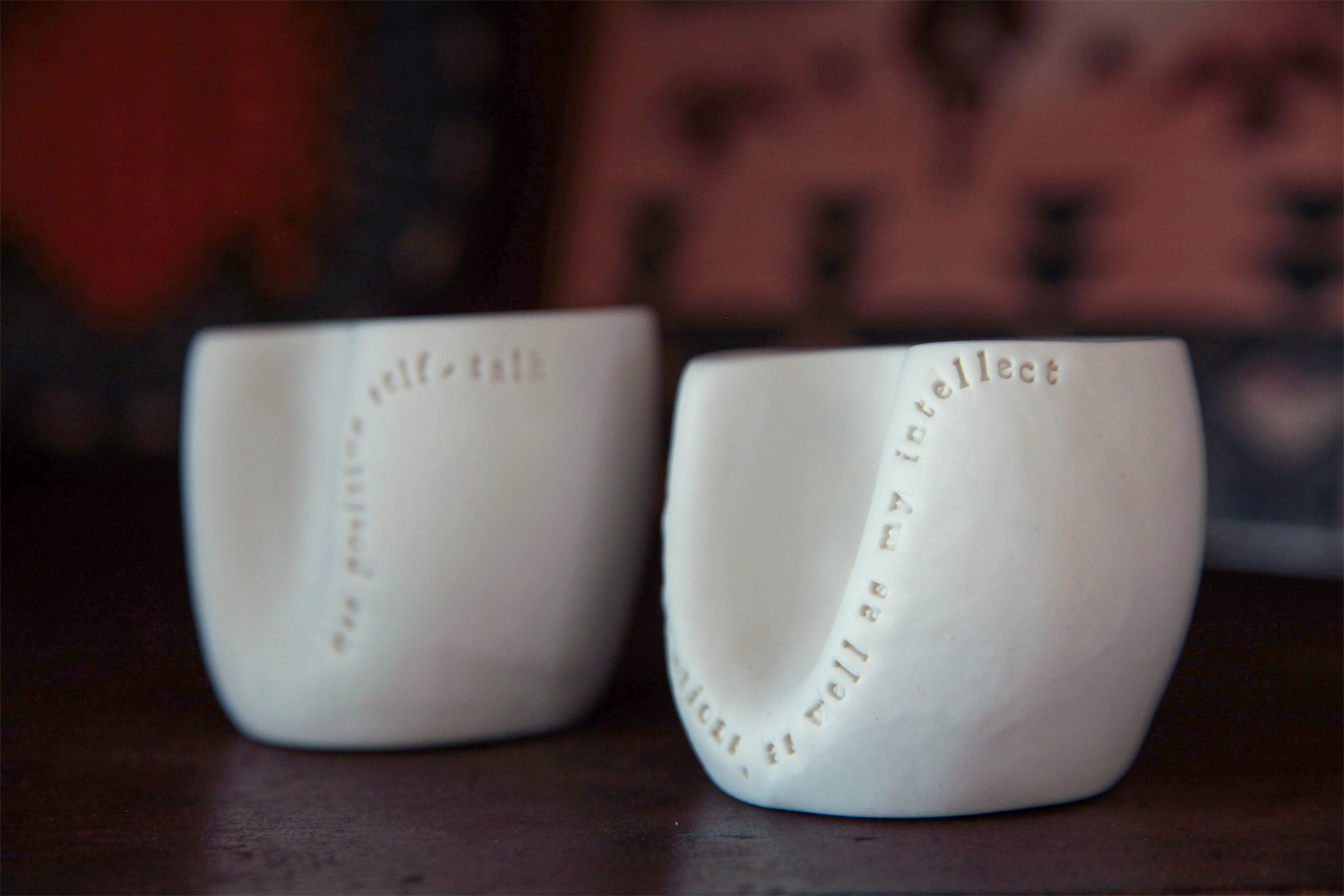 Two cups are placed on a shelf in the community member's home to demonstrate that this individual has agreed to complete these acts of kindness.  The cups serve as a reminder of this experience.