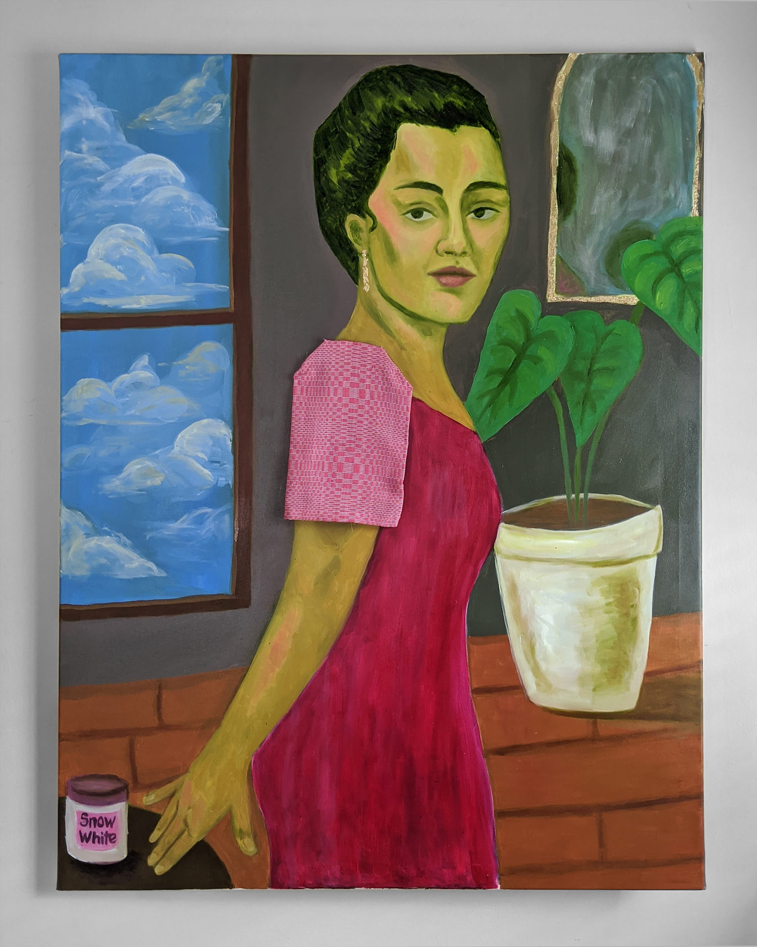 A painting with a woman standing in the middle. Her skin is painted yellow and she is wearing a pink dress. There is cloth attached to the canvas to mimic a sleeve on her dress. There is a window with a bright blue sky and clouds behind her as well as plants. Her hand is resting on a table next to her with a container that says 