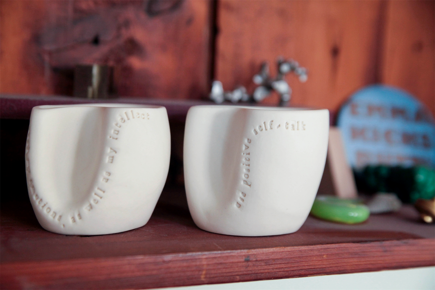 Two cups are placed on a shelf in the community member's home to demonstrate that this individual has agreed to complete these acts of kindness.  The cups serve as a reminder of this experience.