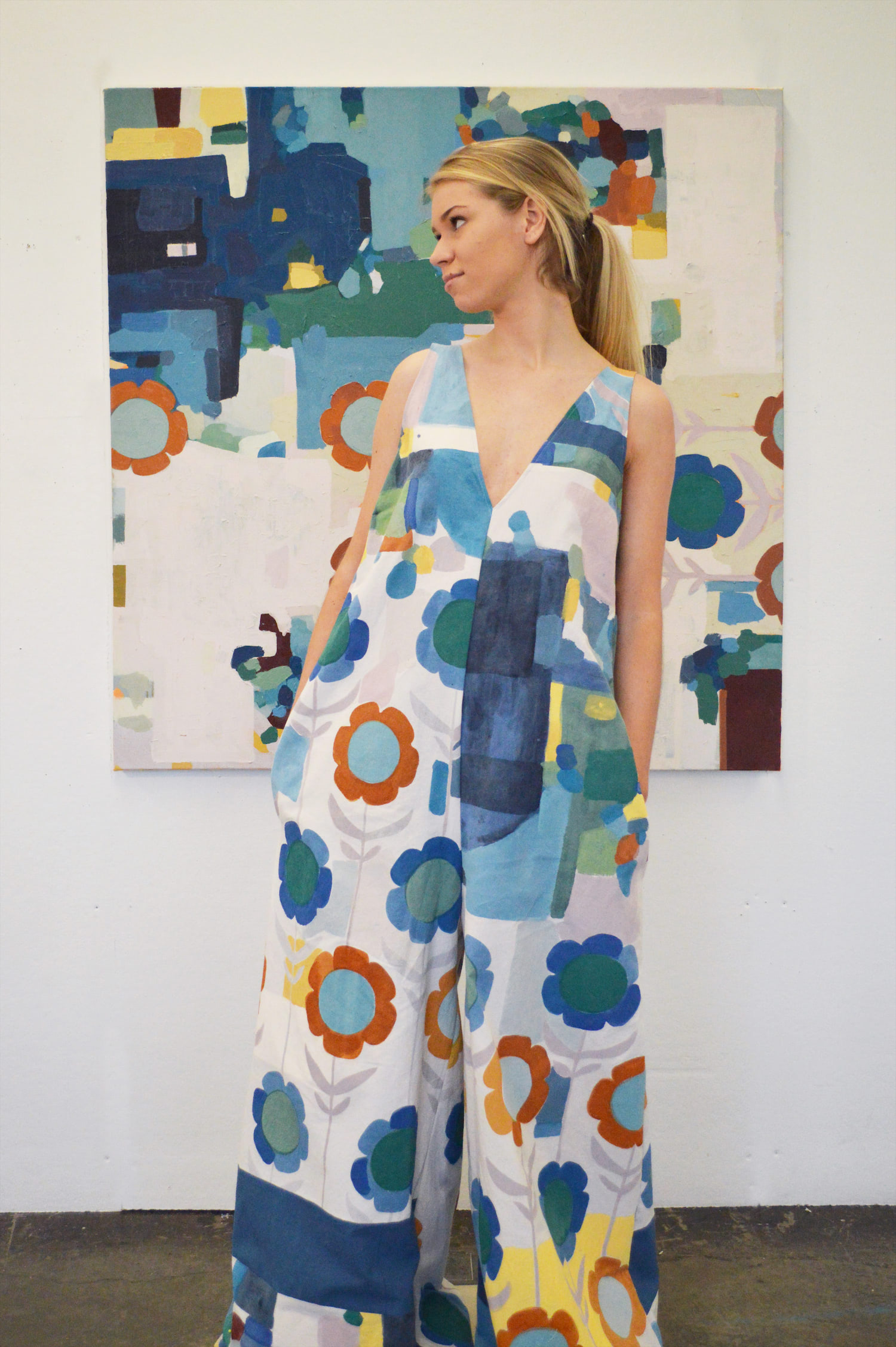 Model standing in front of painting wearing corresponding garment